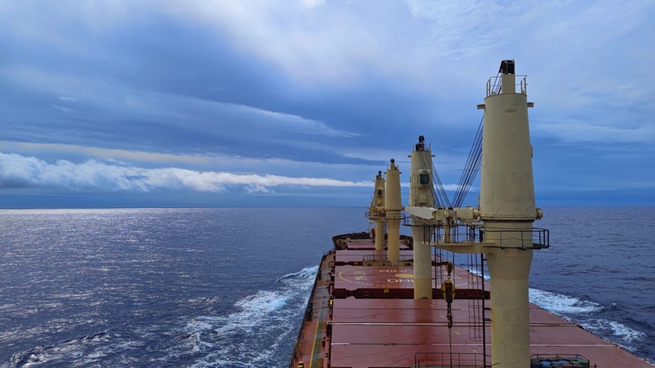 12May23 mid Pacific Ocean. A cargo ship or bulk carrier is sailing at sea with a overcast sky background