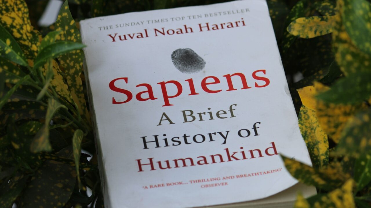 Uttarakhand, India - Feb 26, 2023: Close up of Sapiens: A Brief History of Humankind book by Yuval Noah Harari in a green-yellow leaves