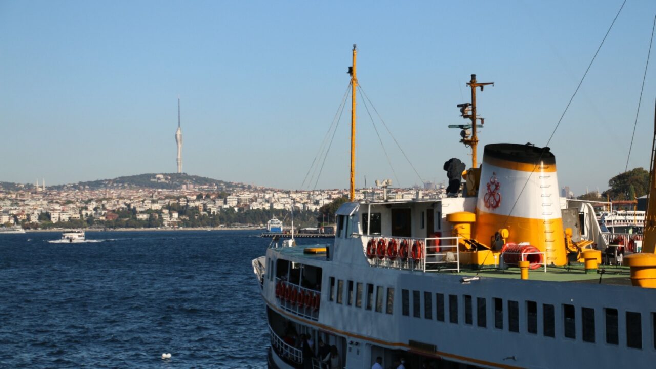 selective focus, 03.08.2021 turkey istanbul: view of newly built tv tower in istanbul's high Çamlıca district with tourist ships from Galata bridge