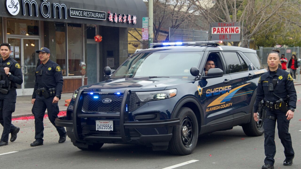 Oakland, CA - Jan 29, 2023: Participants in the first annual Lunar New Year Parade in Oakland. Alameda County Sheriff vehicle and officers walking.