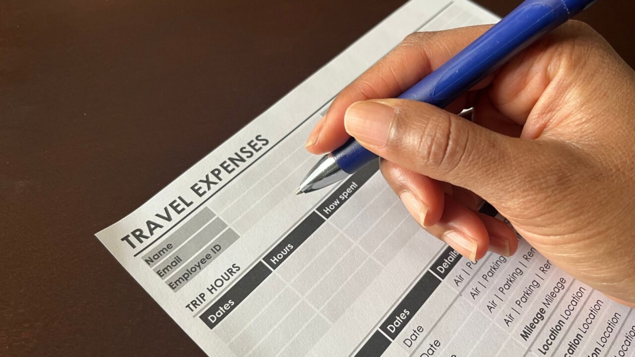 A concept image of a Black person completing a travel expense form