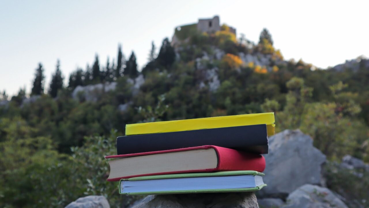 Books on the stone wall under the centuries-old fortress
