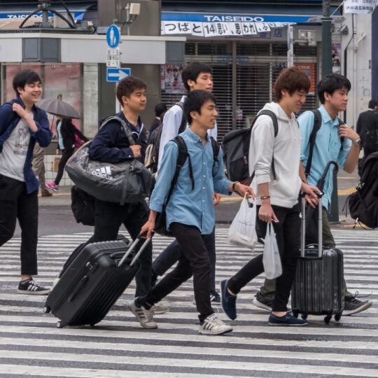 New graduates are delaying travel plans amid a tough U.S. job market