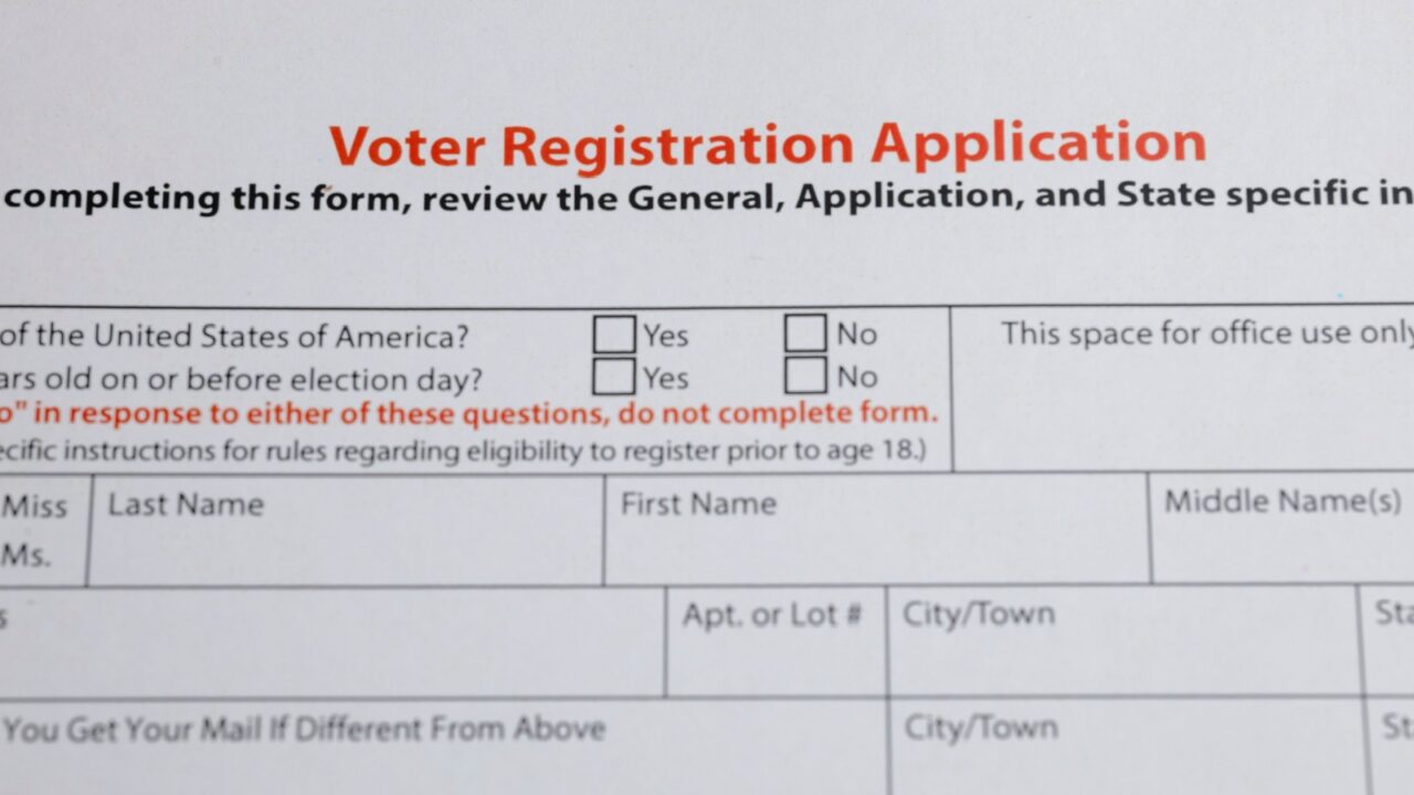 Voter registration application form with fields for personal information and eligibility questions. The form includes checkboxes for citizenship and age.