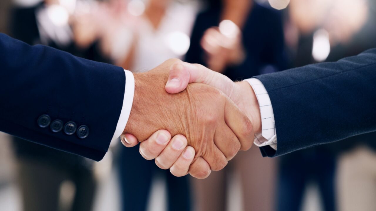 Two man shaking hands in a business setting