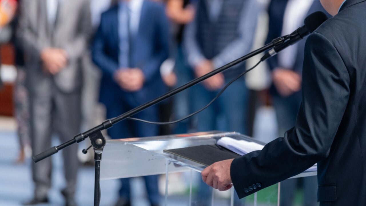 Political campaign before elections with a political candidate addressing an audience with a powerful speech