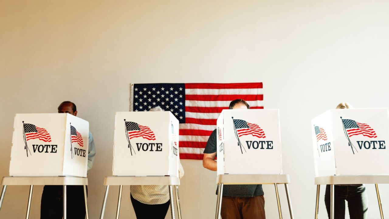 Diverse people at voting booth at US election station