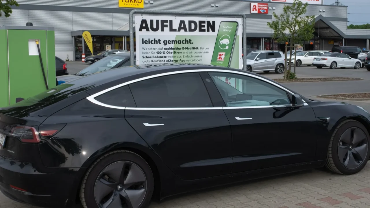 a black tesla model 3 dual motor charging at the