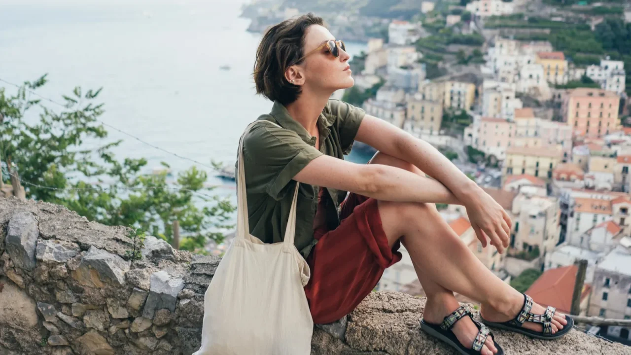a cute teenage girl stands along a handrail overlooking the
