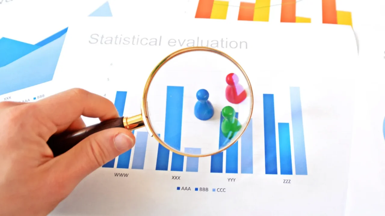 a young man is holding a magnifying glass in his