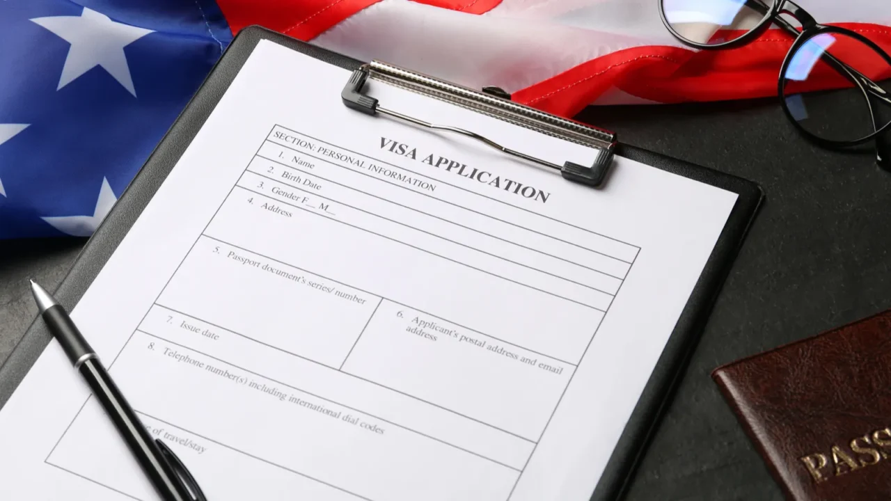 american flag visa application form passport and glasses on black