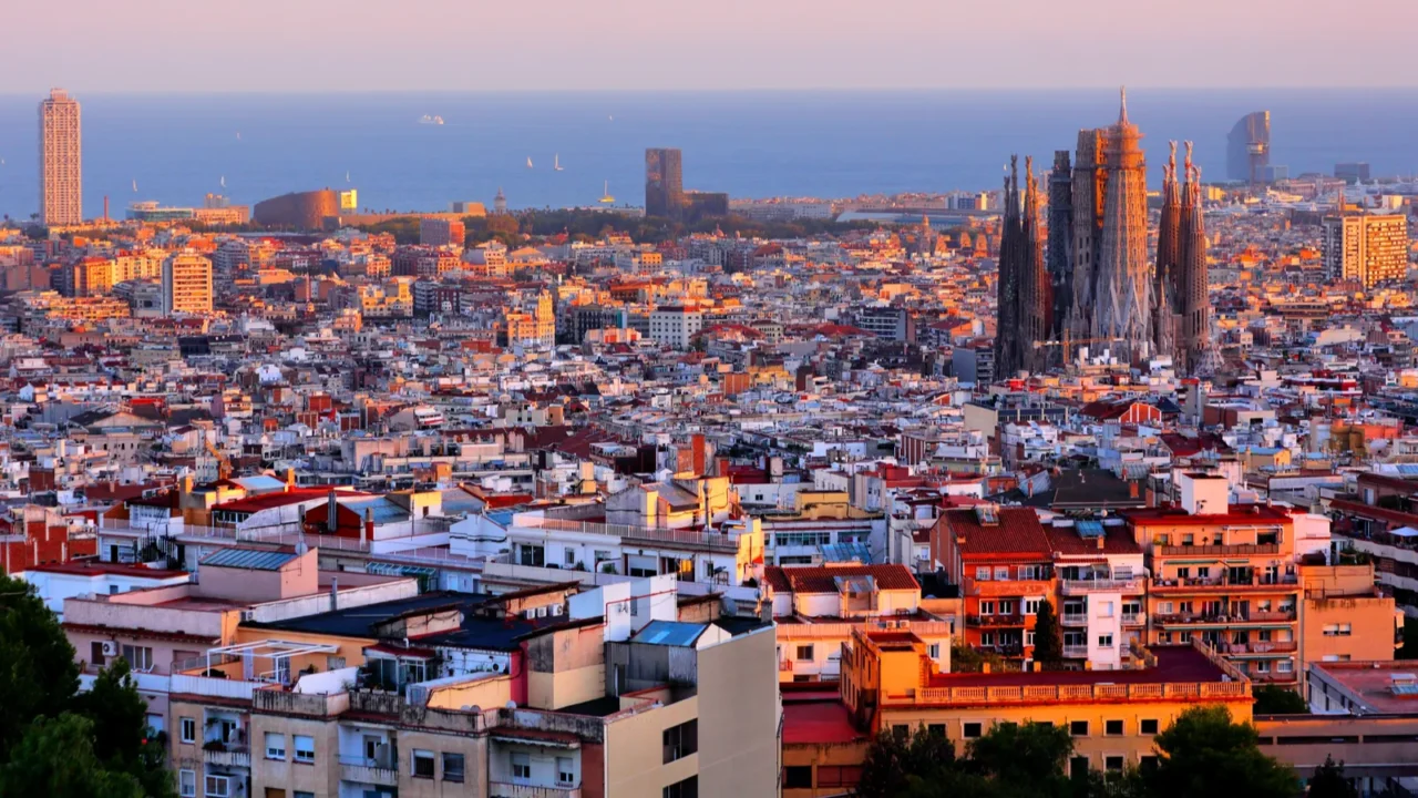 barcelona cityscape with sagrada familia and mediterranean sea in background
