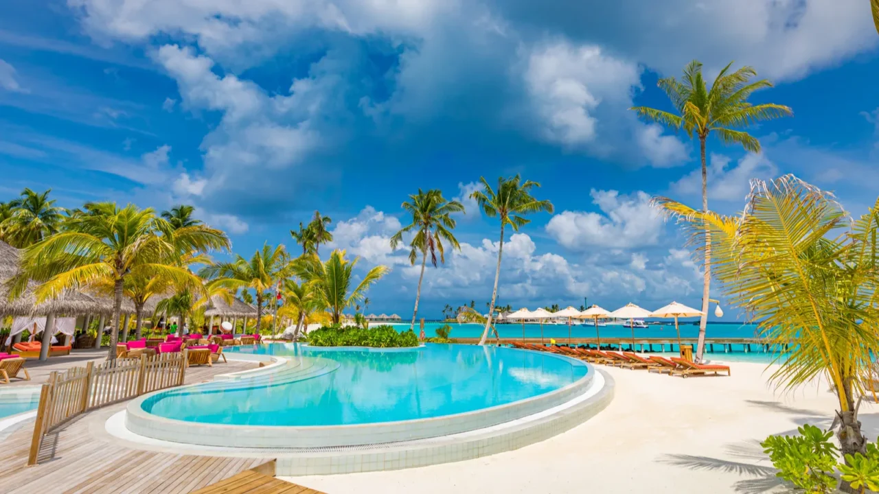 beautiful luxury swimming pool with umbrellas and chairs