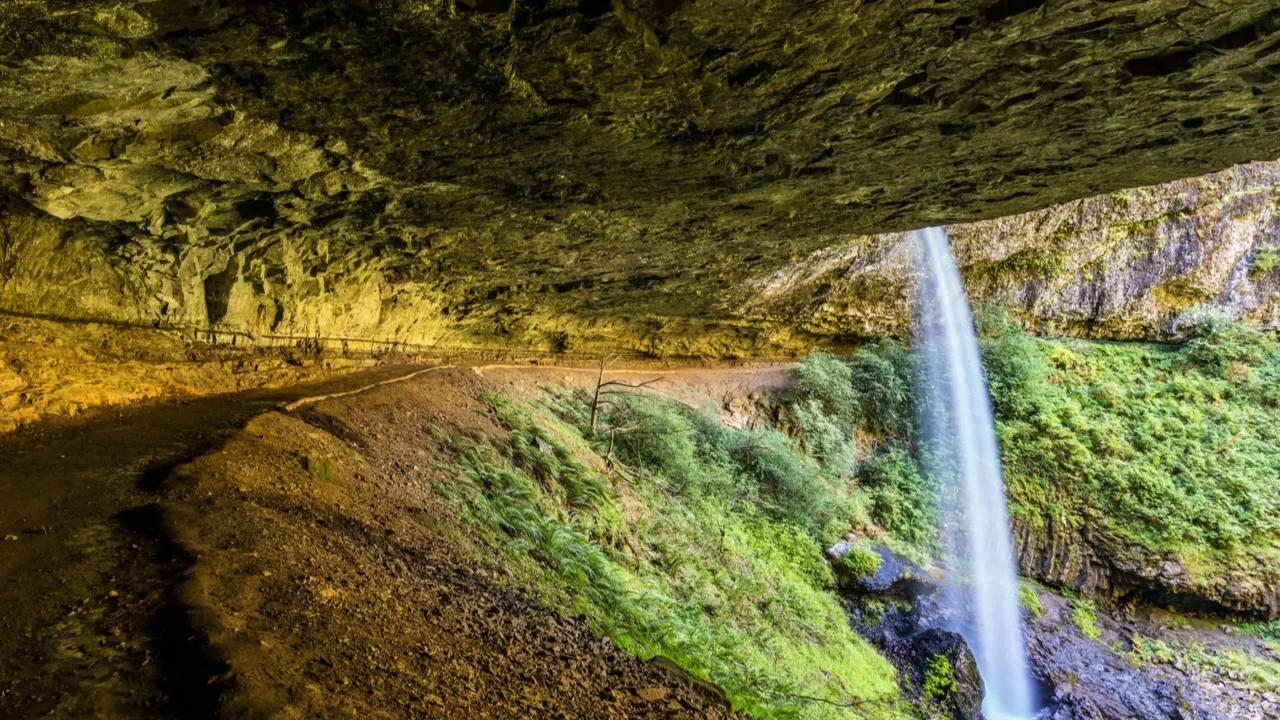 beautiful waterfall with a huge cave like overhang silver falls