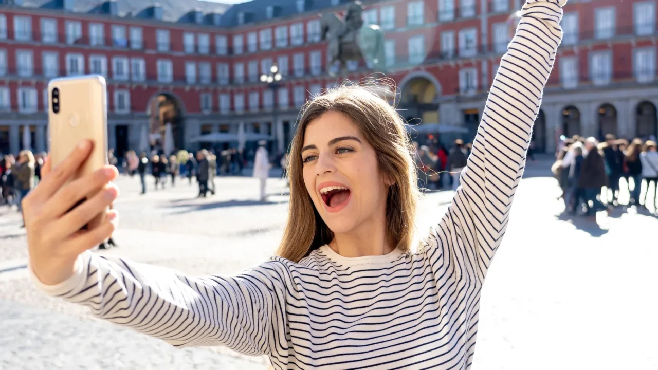 beautiful young caucasian student tourist woman taking a selfie or
