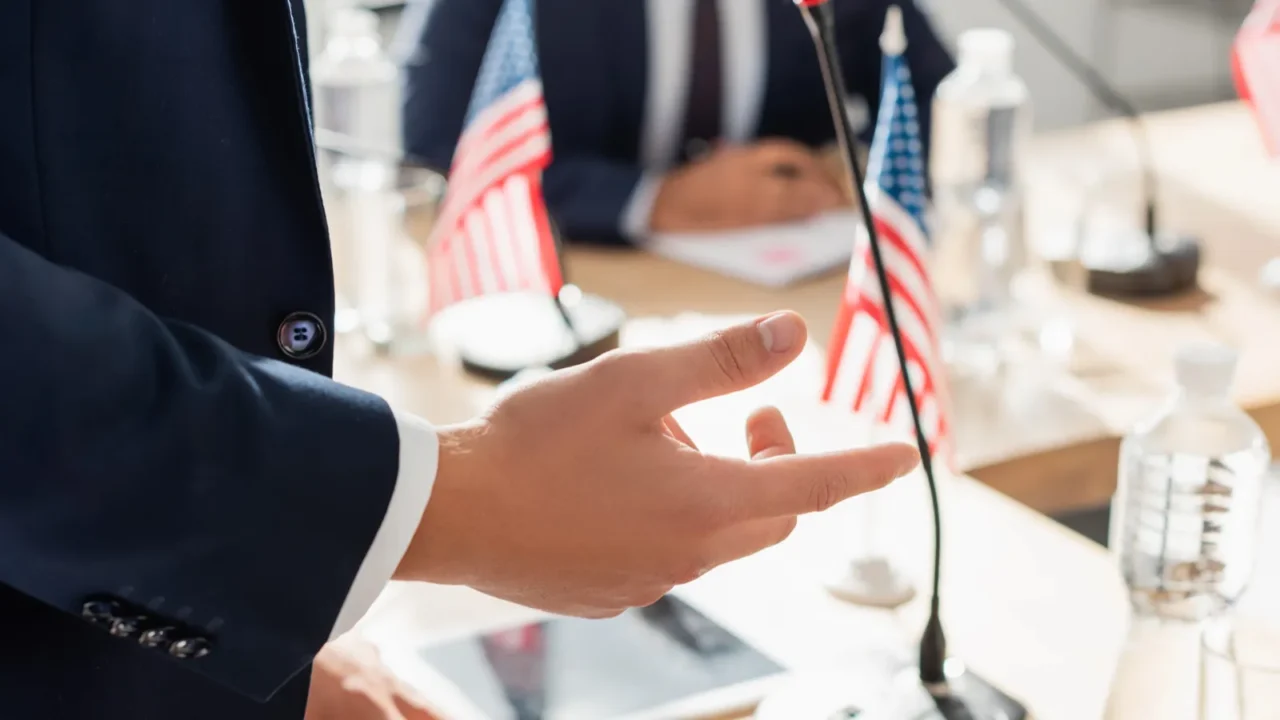 cropped view of politician gesturing while standing during convention with