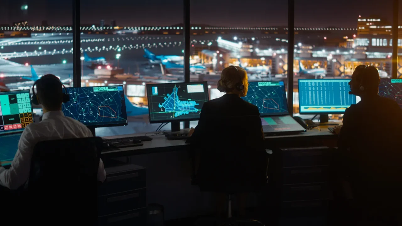 diverse air traffic control team working in modern airport tower