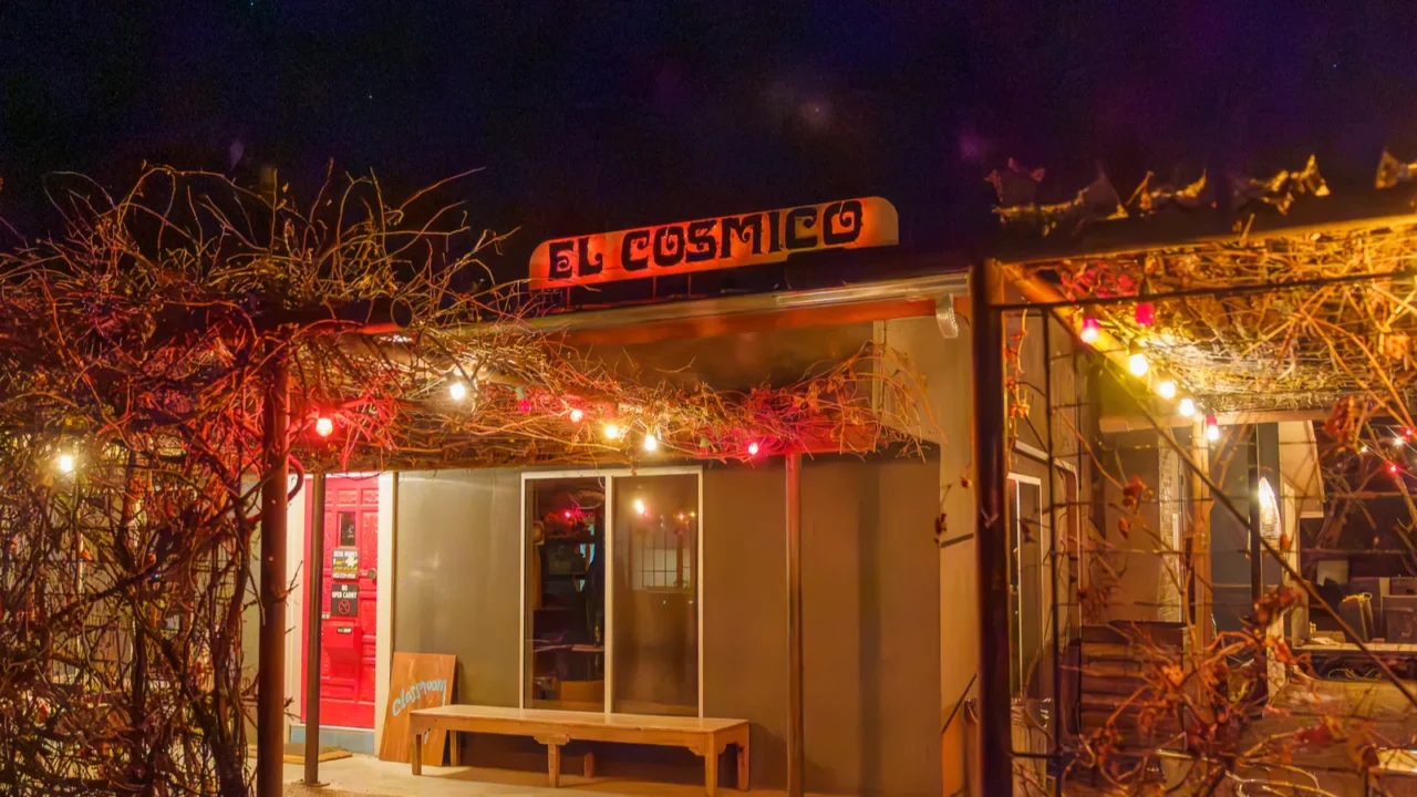 el cosmico front door entrance and sign at night in