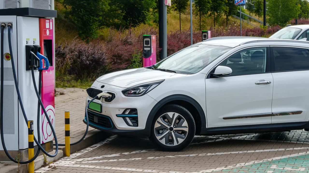 electric cars plugged into a charging station to charge their