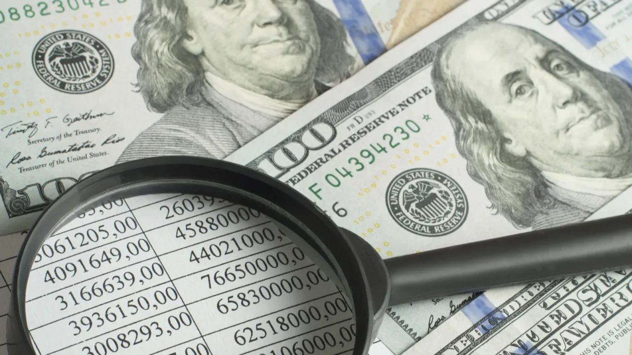 financial and budget concept magnifying glass money and financial document