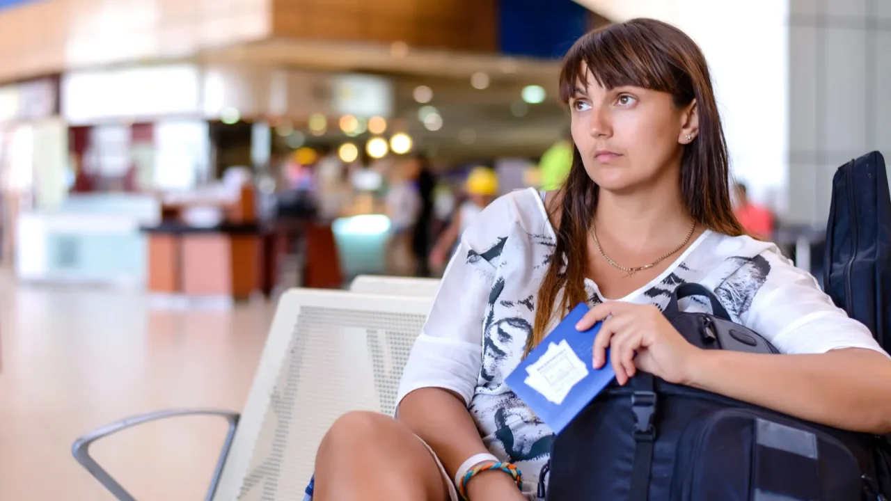 happy middleaged woman in an airport lounge