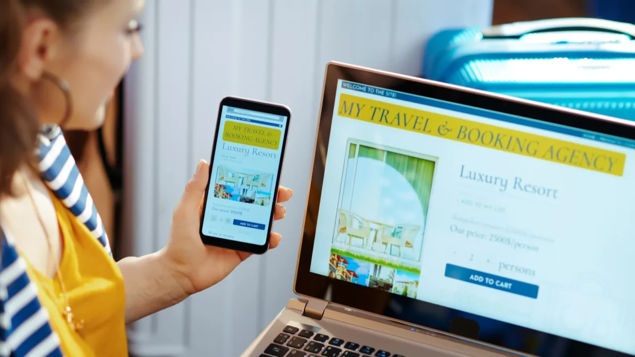 modern tourist woman booking hotel on laptop and smartphone