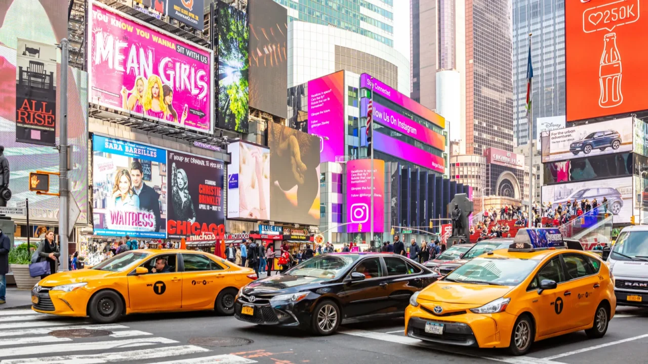 new york times square scyscrapers colorful neon lights ads cars