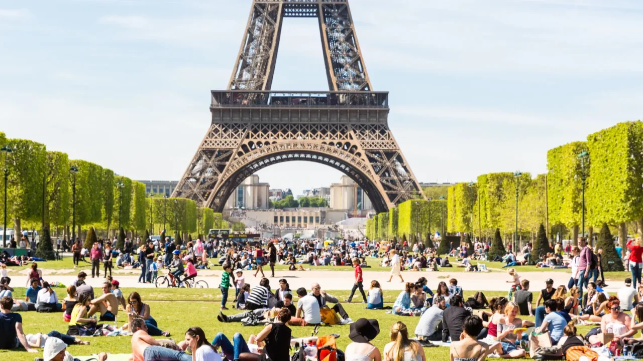 people on champ de mars with eiffel tower on background