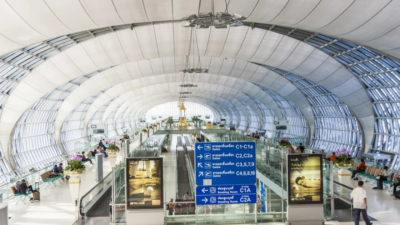 people wait in the departure hall at bangkok airport