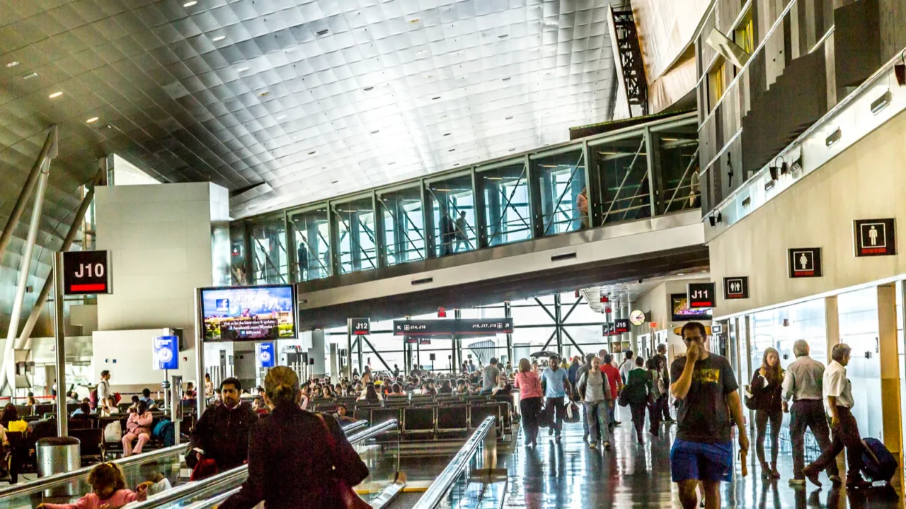 people with baggage on a moving staircase