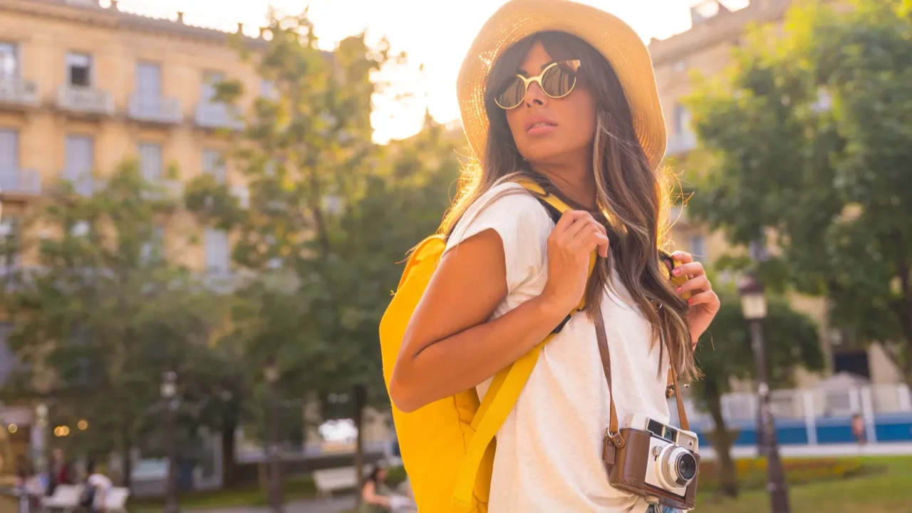 portrait of a tourist in a travel hat at sunset