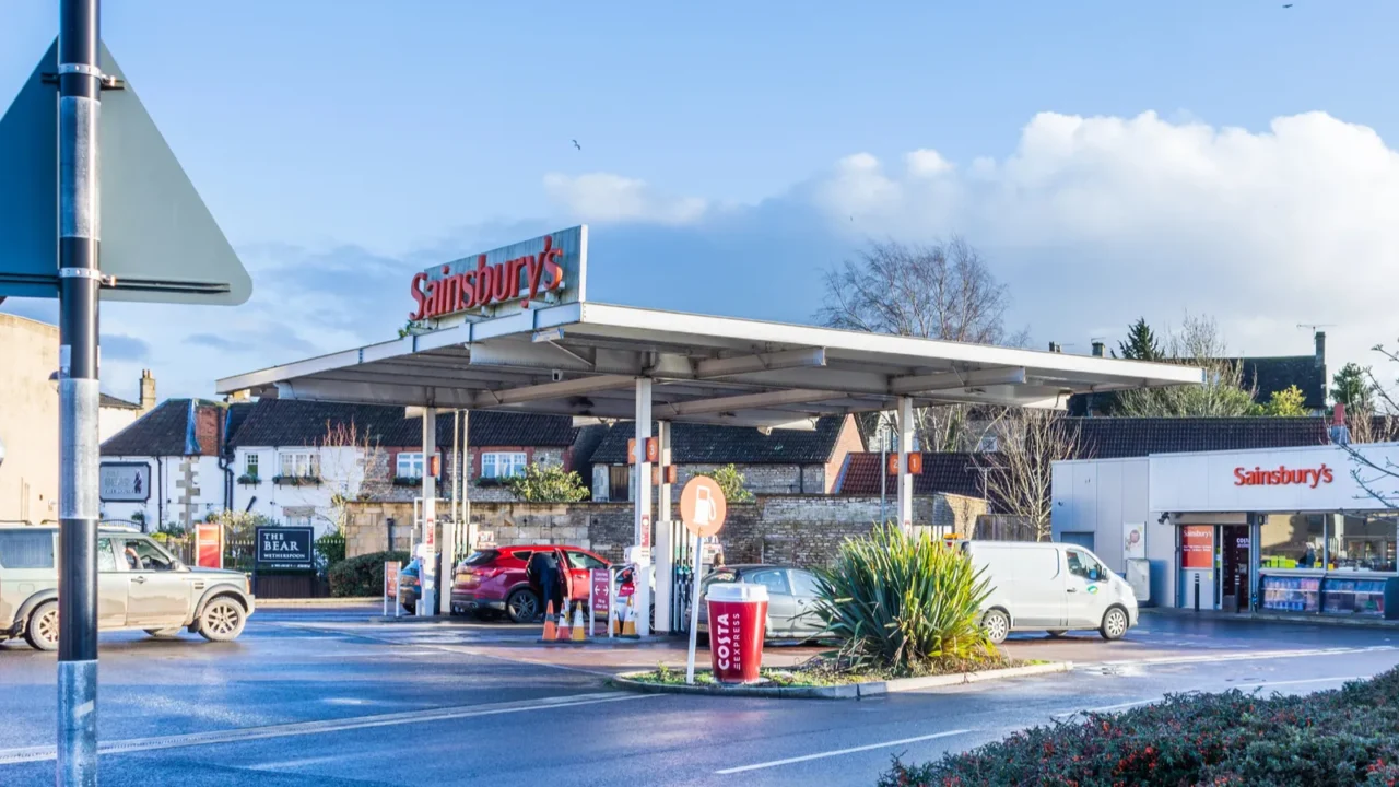 sainsburys fuel station with vehicles queuing on a sunny winter