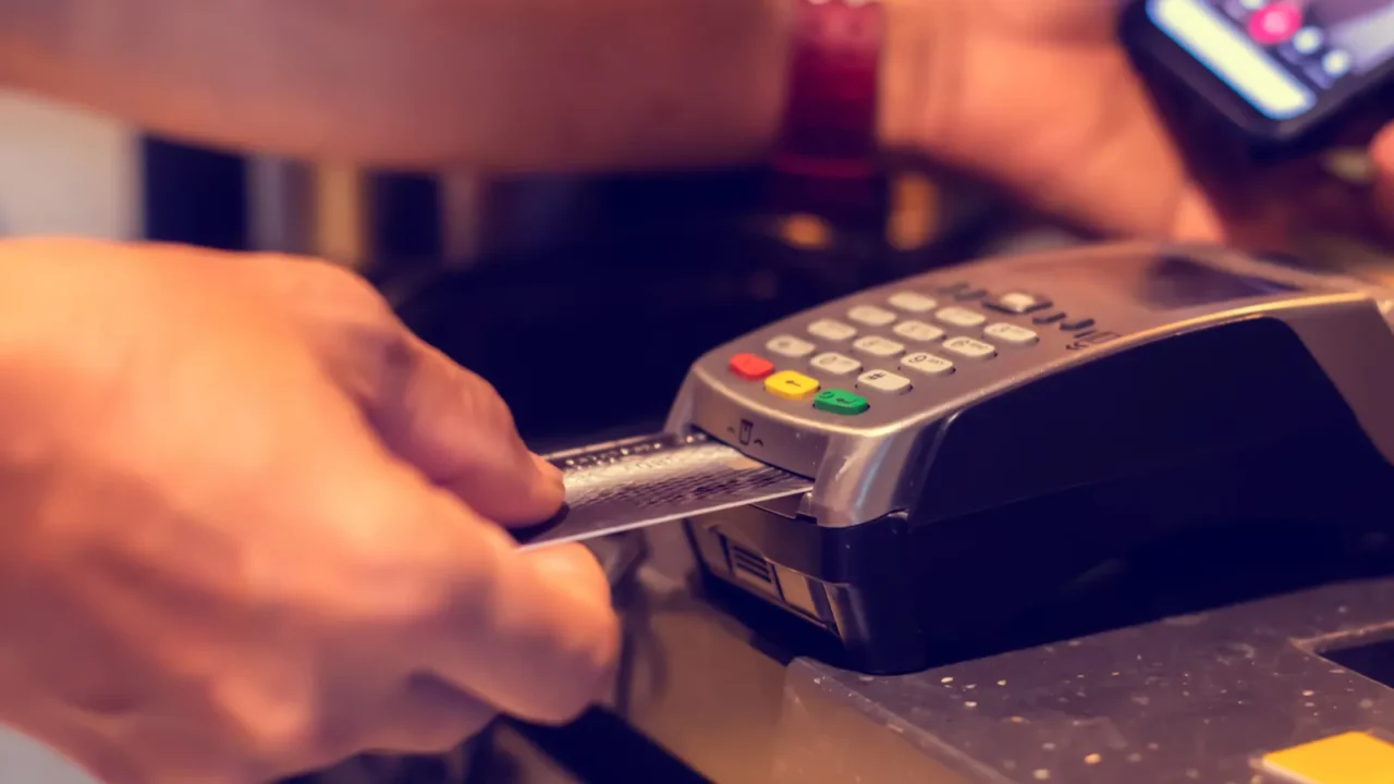 selective focus to credit card reader with blurry hand put
