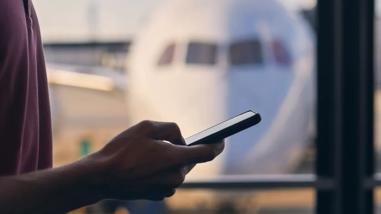 silhouette of hand of passenger while using mobile phone during