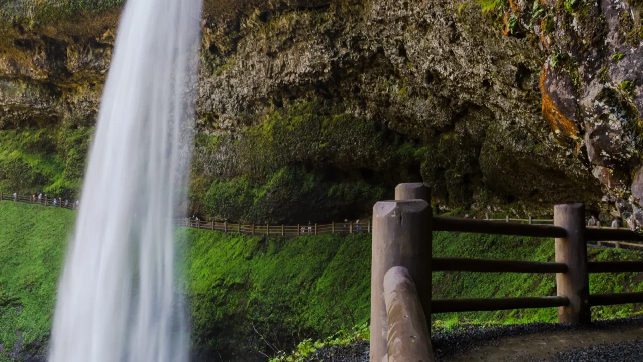  —Beautiful natural scene of silver lake falls in Oregon with blured people in the path behind them.