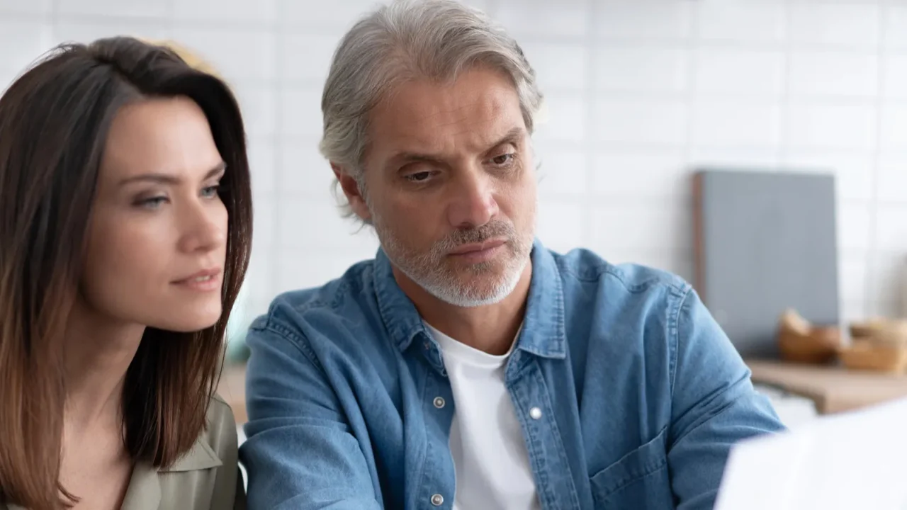 stressed family couple received debt mortgage notification checking financial documents