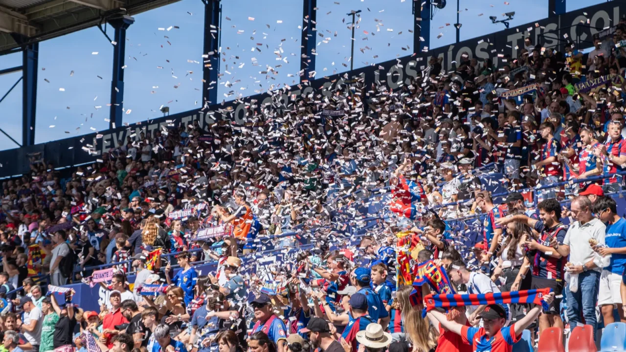 visitors walk through a sunlit corridor inside the estadi ciutat