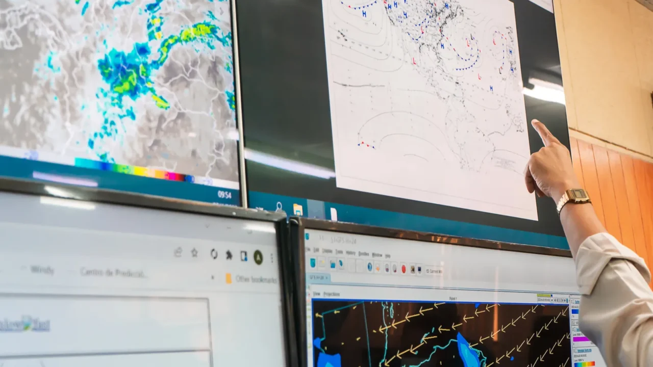 weather prediction by an unrecognizable scientist pointing at the graphs