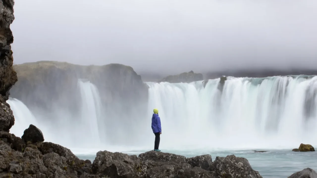 woman on the background of a waterfall iceland