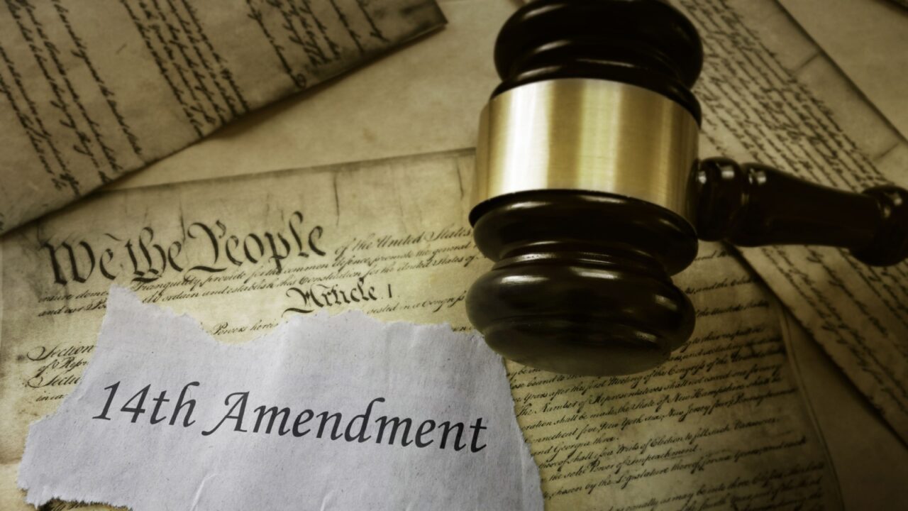 14th Amendment news headline on pages of the US Consitution