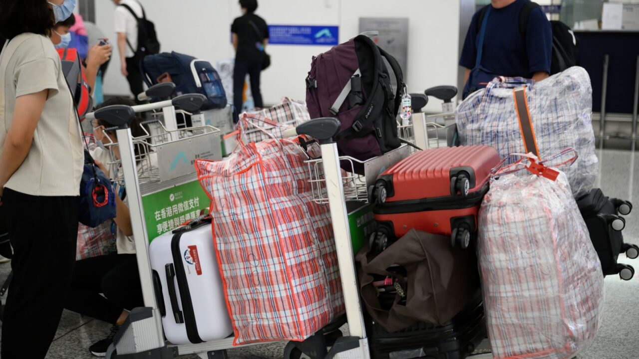 Airport Departures Terminal, HongKong-18July2021: heavy luggage and baggage send to registration center in airport terminal for migration to other countries