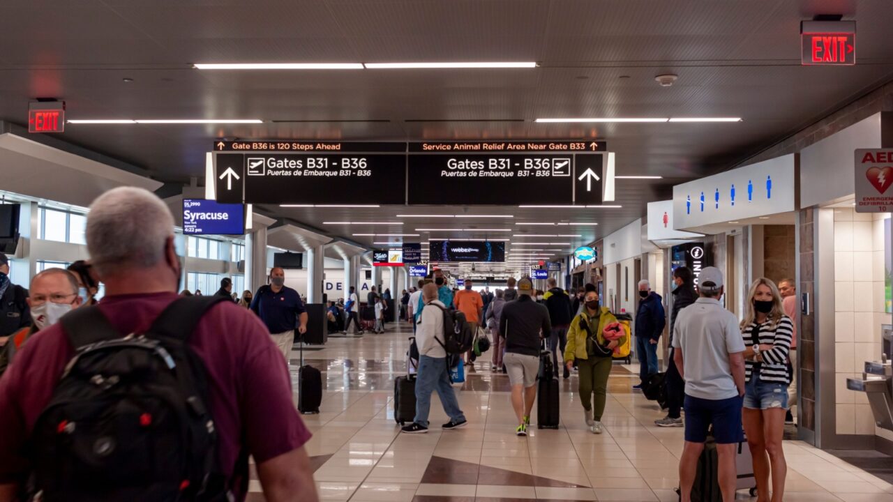 Atlanta, GA, USA 04-03-2022: Interior of the famous Atlanta Hartsfield Jackson International Airport featuring large corridors connecting different terminals, gates, signs, shops and people walking.