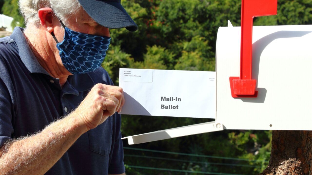 Man mailing in a ballot during the covid-19 pandemic