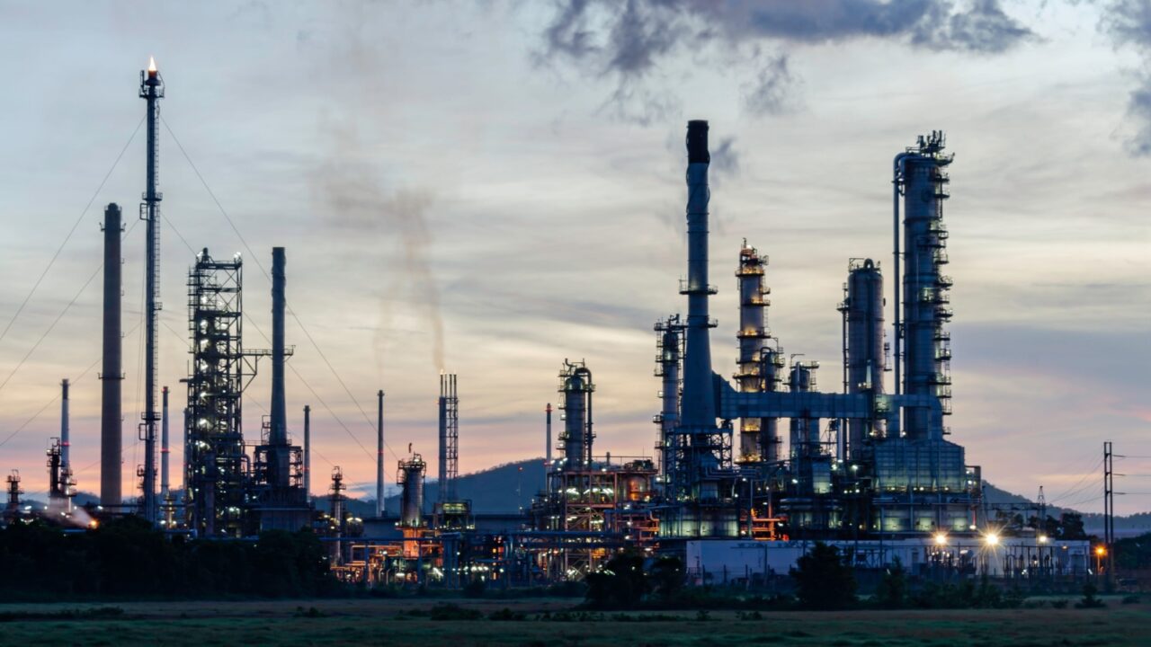 Oil refinery industry at sunset - factory - petrochemical plant