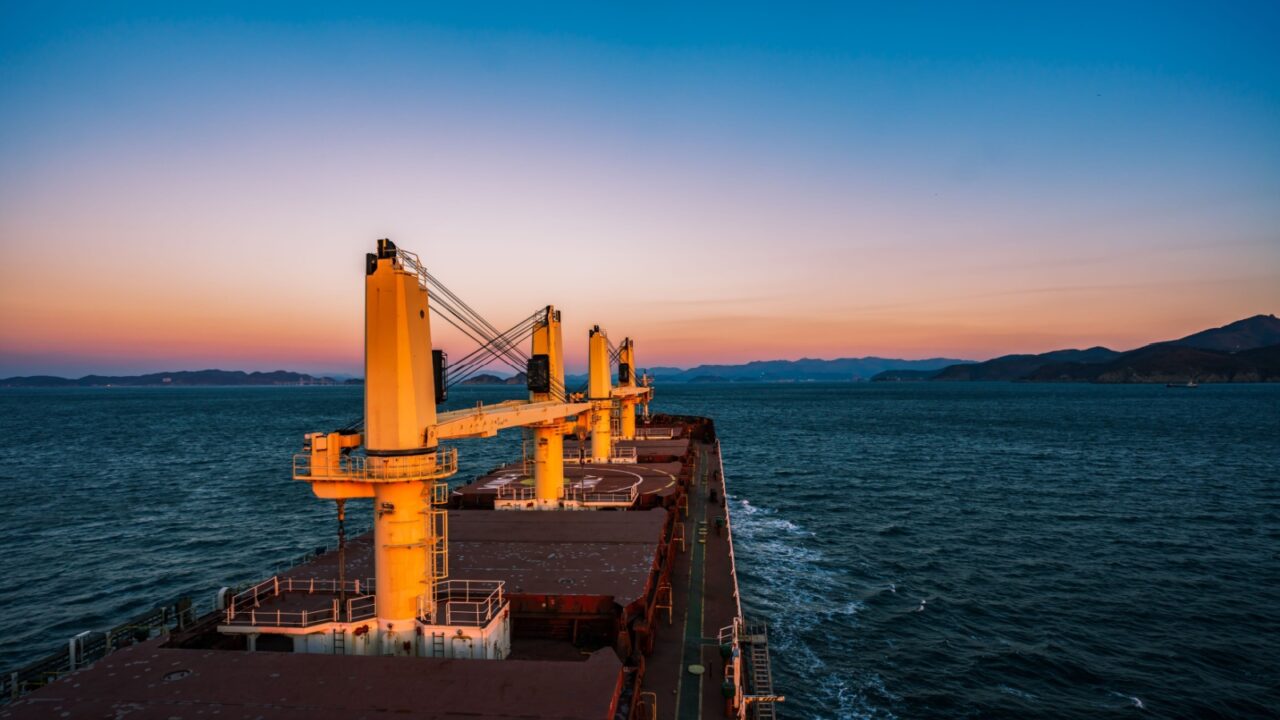 Bulk carrier with the cranes is proceeding to harbour