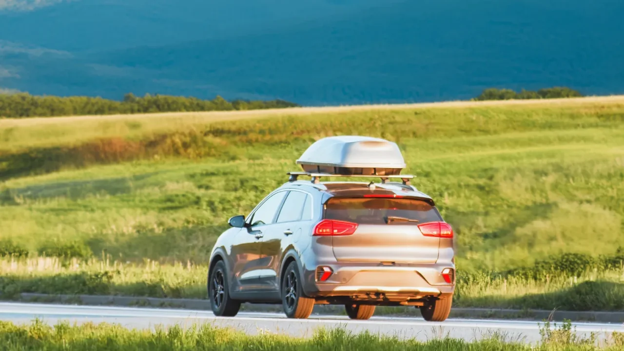car with roofbox on summer road trip