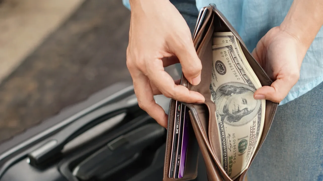 young woman backpacker traveler hands holding wallet dollar currency money