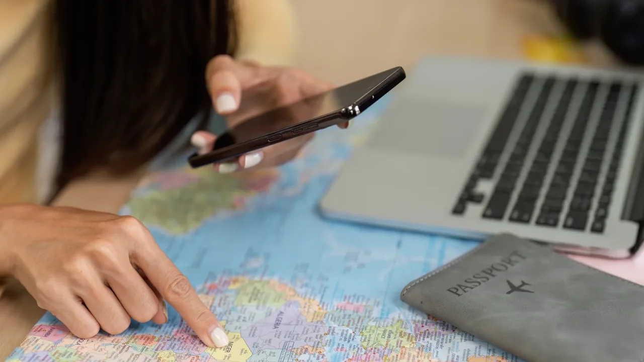 young woman using smartphone to check travel information with a